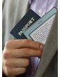 Kindle e-reader: small and light, as shown when held in hand with a passport