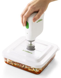 FoodSaver FreshSaver Rechargeable Handheld Vacuum System sealing a FoodSaver container