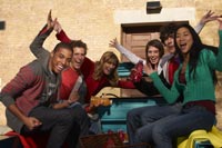 group of friends sitting in the back of a pickup truck