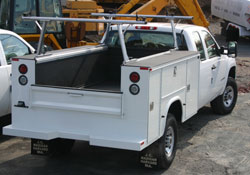 A TracRac 28101 silver 22-inch tall utility rack installed on an unloaded vehicle