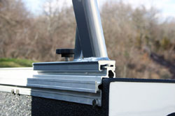 The sliding connection point between rack supports and base rails in the TracRac 28101 silver 22-inch tall utility rack