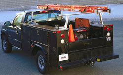 A TracRac 28101 silver 22-inch tall utility rack installed on a loaded vehicle
