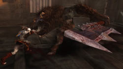 Kratos taking on a boss in God of War: Ghost of Sparta