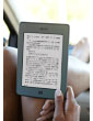 Kindle Touch e-reader: woman reading in car with Kindle Touch on lap