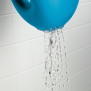 The OXO Tot Whale Pail has small holes in the base which can be used to stream water for rinsing baby's hair