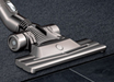 Dual channel floor tool moving from carpet to a wooden floor