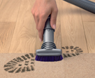 Stubborn dirt brush removing a dirty footprint from the floor